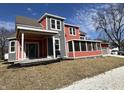 Two-story craftsman home with gray and coral siding, covered porch, and landscaping at 359 N Jefferson St, Martinsville, IN 46151