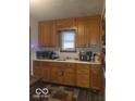 Classic kitchen with wood cabinets and modern appliances at 3915 Brookville Rd, Indianapolis, IN 46201