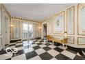 Elegant foyer with a checkerboard floor and ornate wall details at 4601 N Legacy Dr, Muncie, IN 47304
