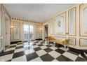 Sophisticated foyer with checkered floors, decorative wall paneling, a bench, and French doors leading to the outside at 4601 N Legacy Dr, Muncie, IN 47304