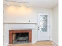 Living room with brick fireplace and wood floors at 4621 E 37Th St, Indianapolis, IN 46218