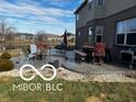 Stamped concrete patio with outdoor seating offers a backyard space for relaxing and entertaining at 5876 Sunnyvale Dr, Bargersville, IN 46106