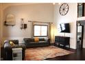 Bright living room featuring hardwood floors, two sofas, and a large TV at 7571 S County Road 825 E, Plainfield, IN 46168
