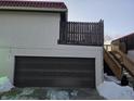 Attached garage with dark brown door and snow on ground at 8360 Paso Del Norte Ct, Indianapolis, IN 46227