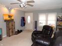 Cozy living room with recliner, ceiling fan, and entryway at 8360 Paso Del Norte Ct, Indianapolis, IN 46227
