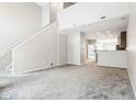 Open living space with high ceilings and stairs to upper level at 1056 Reserve Way, Indianapolis, IN 46220