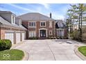 Attractive brick home with a circular driveway and basketball hoop at 10901 Brigantine Dr, Indianapolis, IN 46256