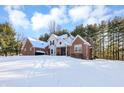 Two-story home with brick and siding exterior, snowy yard at 125 Chalet Dr, Mooresville, IN 46158