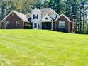 Beautiful home with large yard, brick accents, and black window shutters at 125 Chalet Dr, Mooresville, IN 46158
