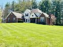 Lovely brick home with a spacious front yard, complemented by mature trees at 125 Chalet Dr, Mooresville, IN 46158