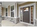 Inviting front entrance with a dark brown door, sidelights, and a stone base at 1271 Clairet Dr, Westfield, IN 46074