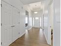 Bright hallway features hardwood floors, white walls, and access to living areas at 1271 Clairet Dr, Westfield, IN 46074
