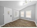 Bright entryway with gray walls, wood floors, and white door at 1430 St Paul St, Indianapolis, IN 46203