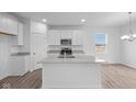 Bright kitchen featuring white cabinetry, stainless appliances, and gray countertops at 1845 James Pierce Dr, Shelbyville, IN 46176