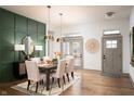 Modern dining room featuring a green accent wall and hardwood floors at 20027 Old Dock Rd, Westfield, IN 46074