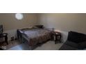 Bedroom with neutral walls, window, bed, and table with lamp at 2301 S Vine St, Muncie, IN 47302