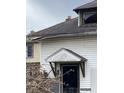 White house with damaged door and porch at 2364 Shelby St, Indianapolis, IN 46203