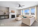Spacious living room with a cozy fireplace, large windows, and comfortable seating at 2449 Lingerman Way, Avon, IN 46123