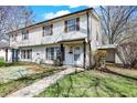 Two-story home features a walkway leading to the front door, complemented by healthy, green lawns at 4814 Oakwood Trl, Indianapolis, IN 46268