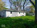 Lush green backyard with mature trees, offering a serene outdoor space at 4818 E 14Th St, Indianapolis, IN 46201