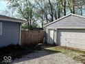 View of a detached garage and wooden fence, creating a private backyard space at 4818 E 14Th St, Indianapolis, IN 46201