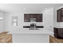 Modern kitchen with stainless steel appliances, quartz countertops, and ample cabinet space at 5123 Rolling Meadow Blvd, Indianapolis, IN 46237