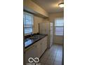 Efficient kitchen with white cabinets and double sink at 5414 E 11Th St, Indianapolis, IN 46219