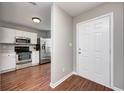Entryway with white door and view into kitchen with stainless steel appliances at 5620 Thompson Park Blvd, Indianapolis, IN 46237