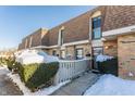 Front view of brick townhouses with snow-covered landscaping at 7421 Country Brook Dr, Indianapolis, IN 46260