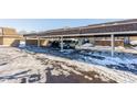 Carport with two cars parked, surrounded by snow at 7421 Country Brook Dr, Indianapolis, IN 46260