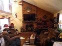 Living room features a brick fireplace and hardwood floors at 7569 Farm View E Cir, Indianapolis, IN 46256