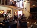 Spacious living room with fireplace, vaulted ceiling and hardwood floors at 7569 Farm View E Cir, Indianapolis, IN 46256