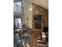 Inviting living room featuring a brick fireplace, high ceilings, and an open loft area at 7569 Farm View E Cir, Indianapolis, IN 46256