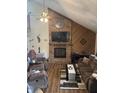 Comfortable living room showcasing a brick fireplace with wooden mantle and plush sofas at 7569 Farm View E Cir, Indianapolis, IN 46256