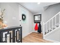 Bright entryway with coat rack and stairs at 7802 Hardwick Pl, Fishers, IN 46038