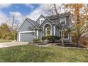 Gray two-story house with a yellow door, two-car garage, and landscaped yard at 11126 Indian Lake Blvd, Indianapolis, IN 46236