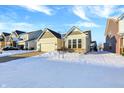 Snow covered front yard of charming ranch home in a neighborhood setting at 1128 Sorrell Pass, Greenwood, IN 46143