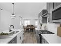 Open concept kitchen with gray cabinets and white countertops at 1302 English Ave, Indianapolis, IN 46203