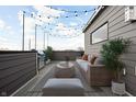 Relaxing rooftop deck with seating, grill, and string lights at 1302 English Ave, Indianapolis, IN 46203