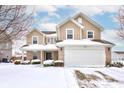 Two-story house with brick and siding, covered in snow, and a two-car garage at 15317 Black Gold Ct, Noblesville, IN 46060