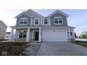 Two-story house with gray siding, white garage door, and stone accents at 16775 Cheddar Dr, Noblesville, IN 46060