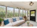 Relaxing sunroom features a wicker sofa, creating a cozy atmosphere at 1921 E Pleasant Run Pkwy S S Dr, Indianapolis, IN 46203