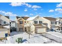 Two-story house with brick exterior, two-car garage, and snow-covered yard at 5632 Wild Horse Dr, Indianapolis, IN 46239