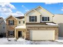 Two-story house with brick and vinyl siding, two-car garage, and snow-covered yard at 5632 Wild Horse Dr, Indianapolis, IN 46239