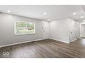 Bright living room with hardwood floors, a fresh coat of paint, recessed lighting and a large window at 5807 Westhaven Dr, Indianapolis, IN 46254