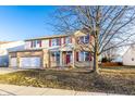 Lovely two-story home with brick accents, red shutters, and a well-kept lawn under a clear blue sky at 5838 W Bayfield Dr, McCordsville, IN 46055