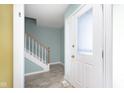 Bright entryway with tiled floor, staircase, and white door at 6459 Schmus Ct, Indianapolis, IN 46268