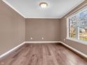 Cozy bedroom with hardwood floors, neutral paint, a window and baseboard trim at 6663 Trailside Dr, Avon, IN 46123