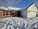 Brick and white sided Ranch home with red shutters and snowy landscaping at 837 Trotter Ct, Greenwood, IN 46143