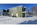 Green house exterior with HVAC units and snowy ground at 841 Udell St, Indianapolis, IN 46208